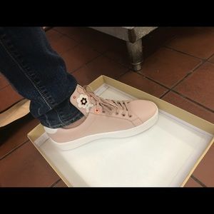 Rose pink MIcheal kors shoes with flower design.